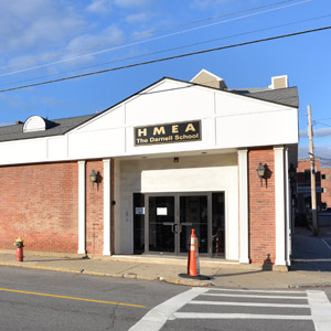 The Darnell School, outside front of brick building with a sign that says HMEA