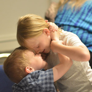 a small boy and girls hugging