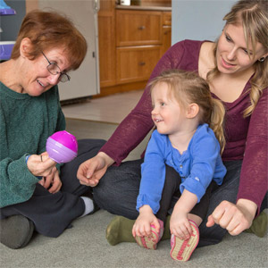 a mother and toddler receiving ABA services from a female HMEA staff person